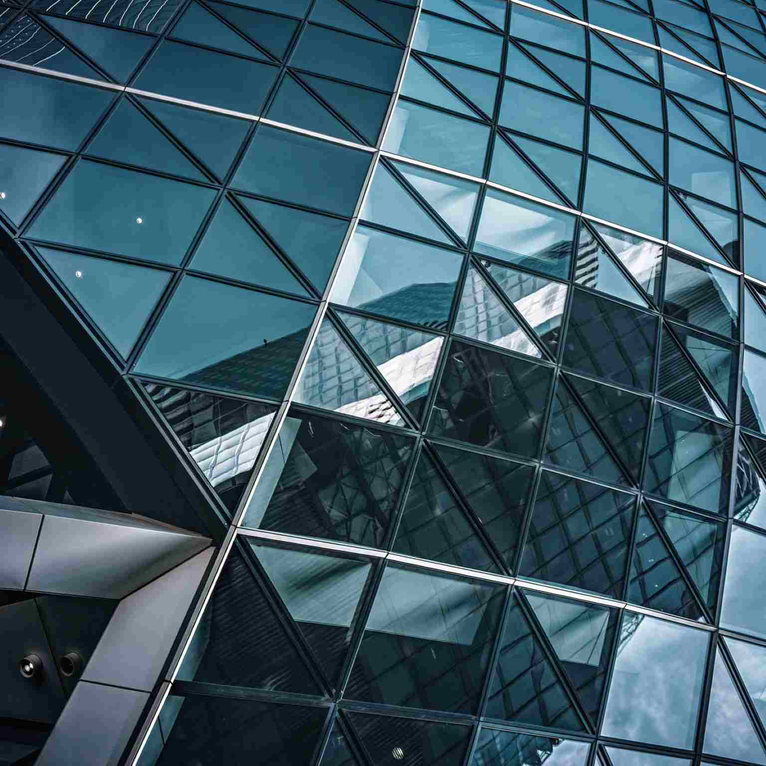 Modern glass skyscraper with geometric reflections